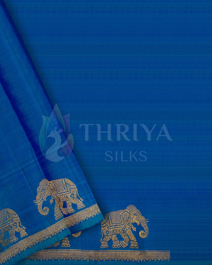 Blouse piece of peacock blue silk saree with gold zari elephant border design