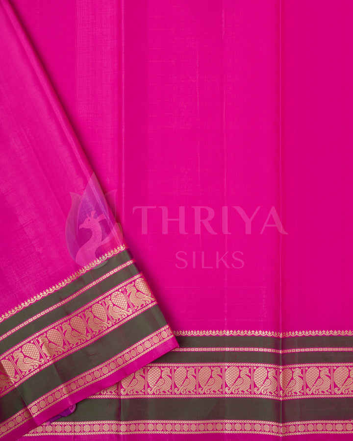 Rich pink blouse piece with olive green and gold zari border, complements the cream saree from Thriya Silks