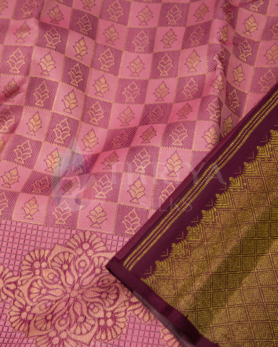 Close-up of pink and brown Kanjivaram silk saree with floral motifs and golden zari border