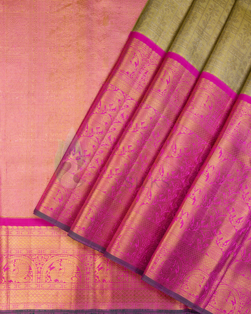 Pink and gold Kanchipuram silk saree folded neatly, showcasing intricate traditional motifs and vibrant golden border