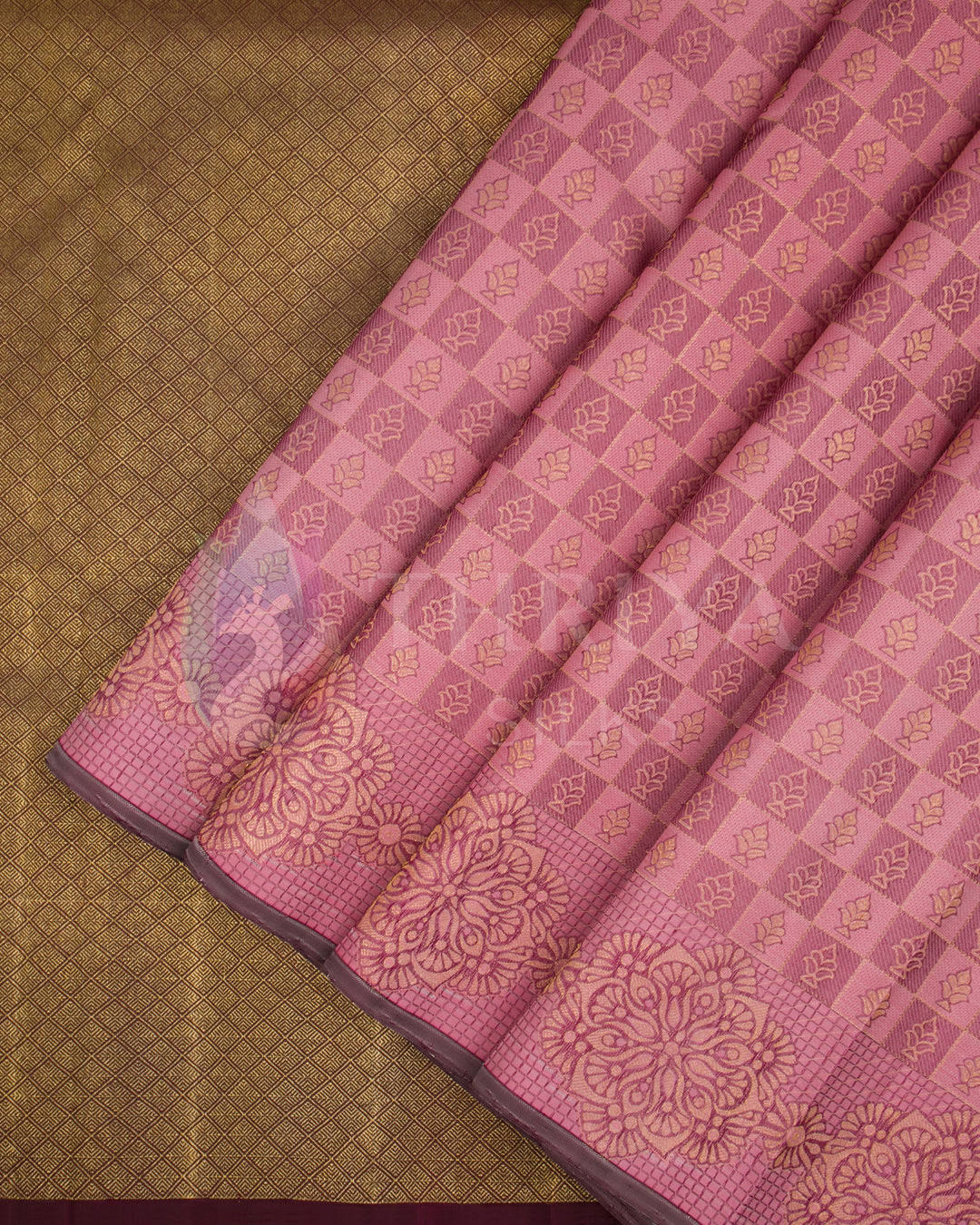 Pink Kanjivaram silk saree pleats with golden check pattern and brown zari border