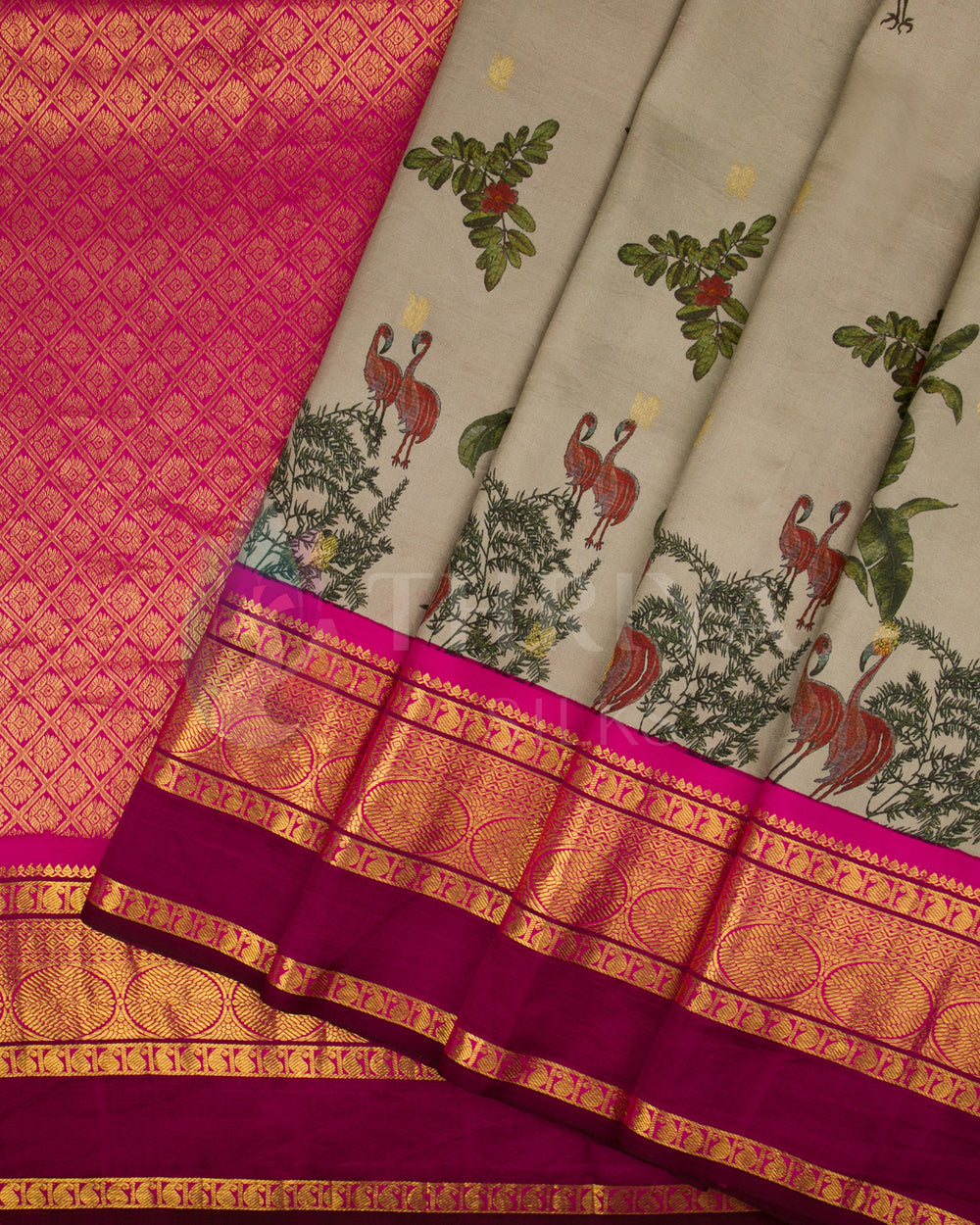 Pleated view of beige silk saree highlighting the bird motifs and detailed pink-gold zari work.