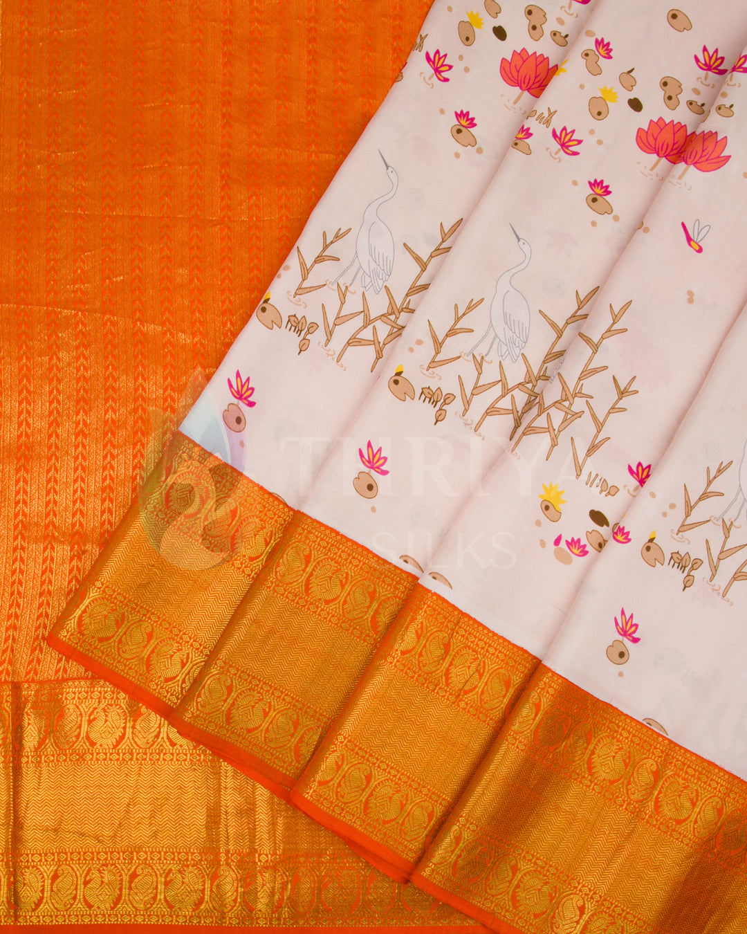 Pleated view showcasing detailed bird and lotus design with a vibrant orange zari pallu and border.