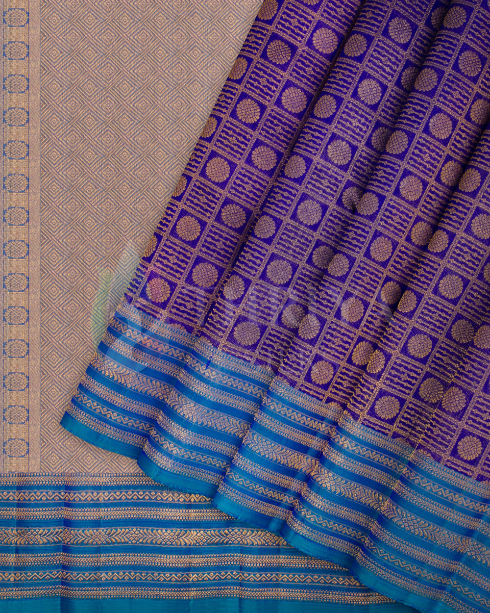 Purple and blue Kanjivaram silk saree with golden jacquard pleats and blue zari border