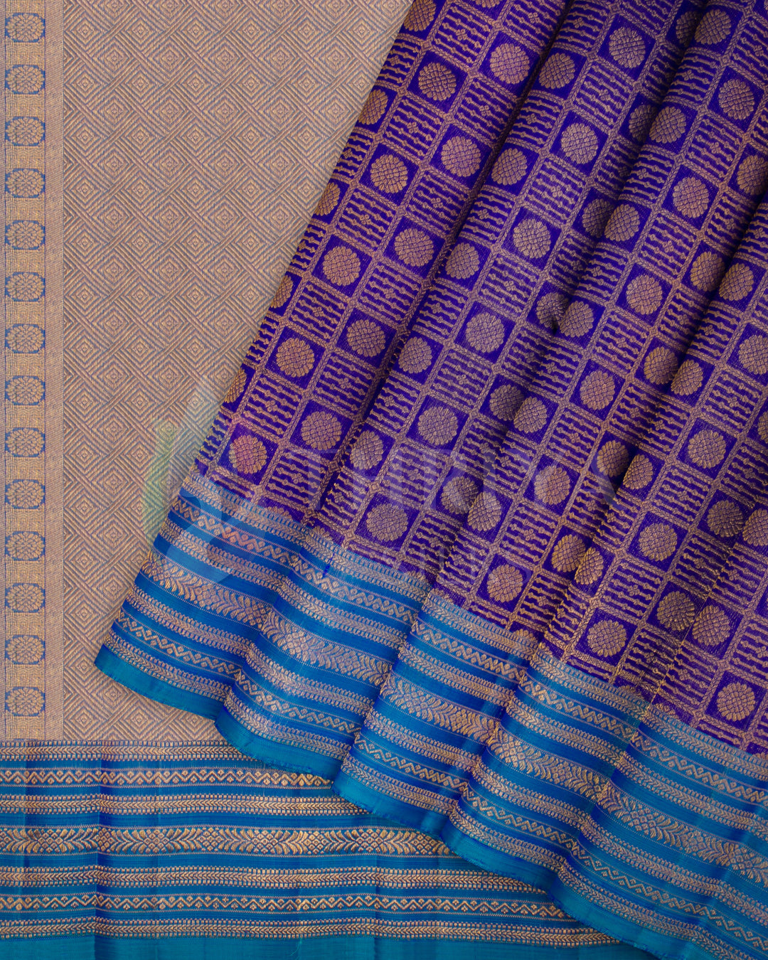 Purple and blue Kanjivaram silk saree with golden jacquard pleats and blue zari border