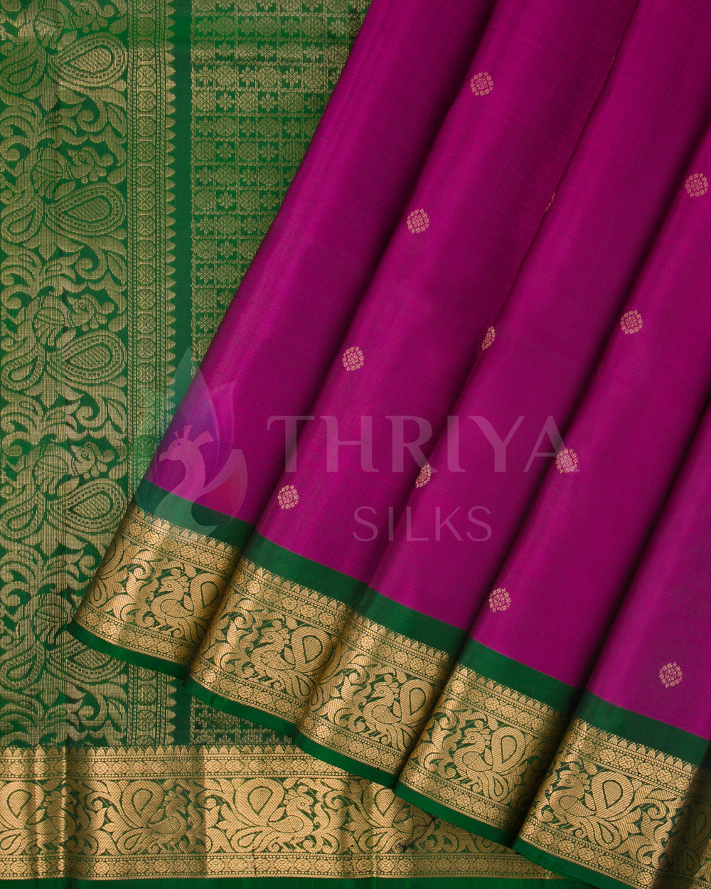 Purple Kanjivaram silk saree with green border and gold zari work on pleats and pallu