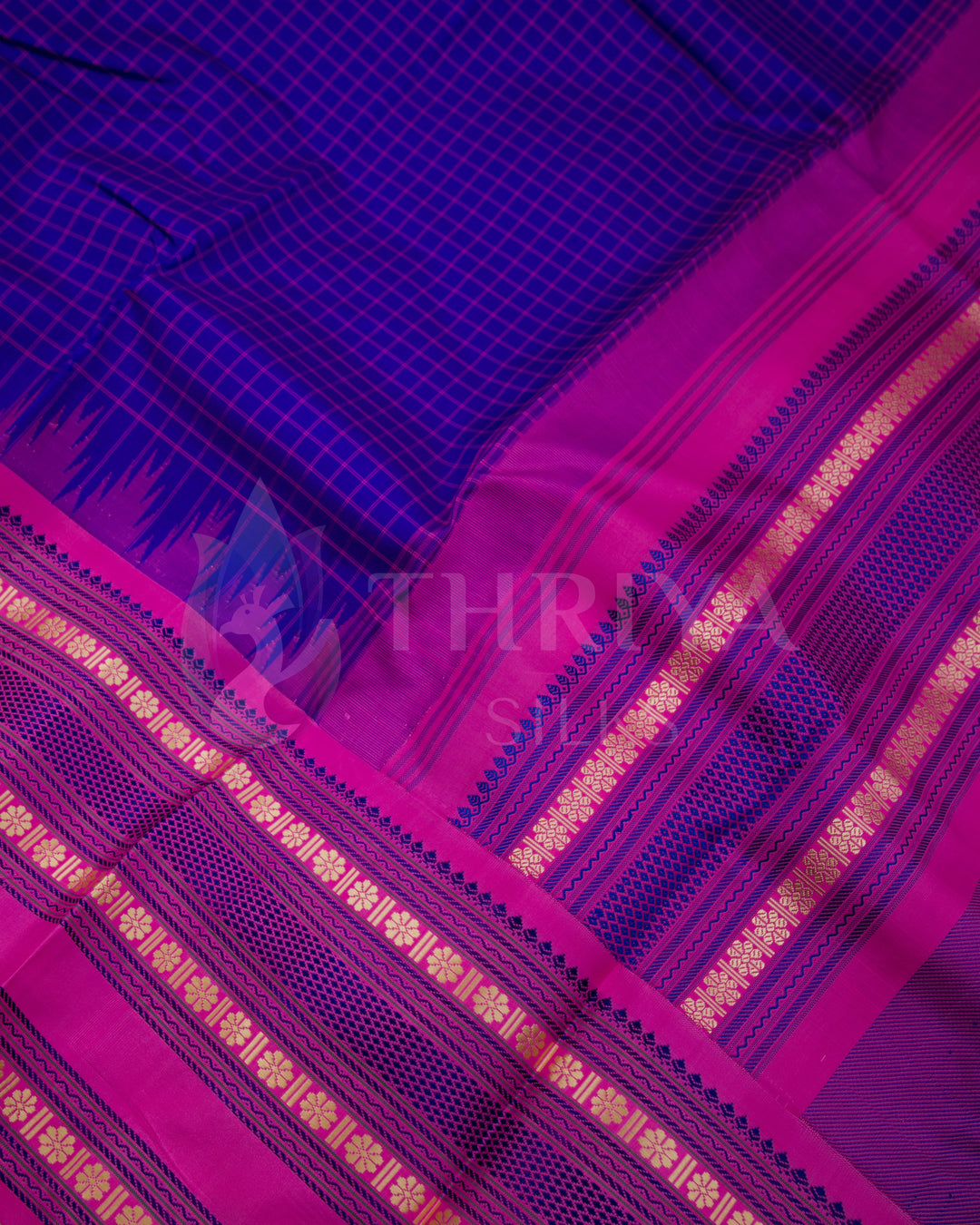 Close-up of purple silk saree fabric and intricate pink and gold zari border, Thriya Silks
