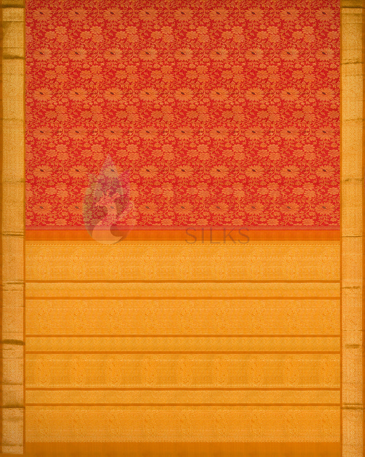 Full spread flat lay of red and gold Kanchipuram silk saree showcasing detailed floral motifs and rich golden zari border
