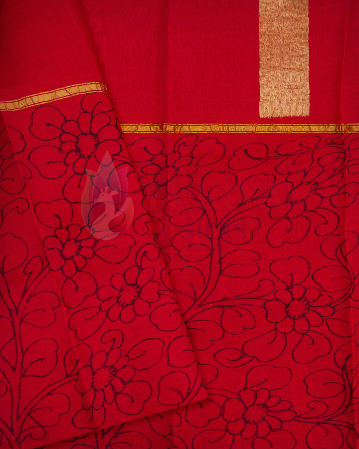 Red handloom silk saree featuring elegant black floral weaving on the border