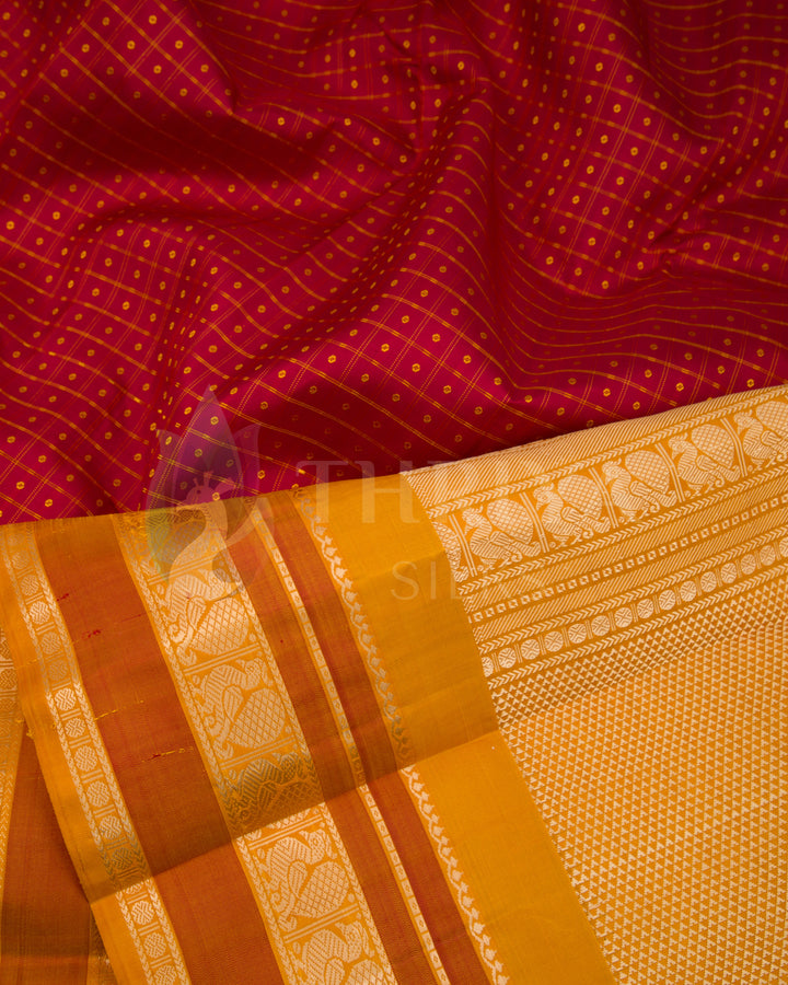 Close-up of red silk saree body with diamond pattern and mustard yellow pallu with intricate zari work, Thriya Silks