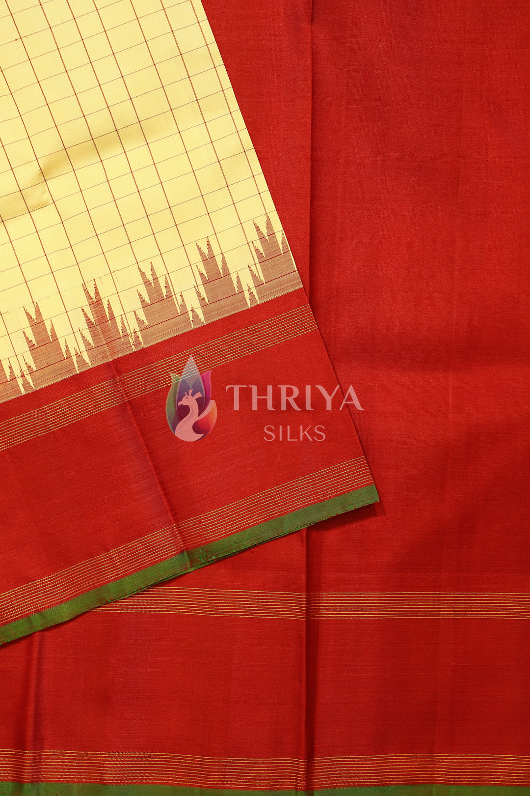 Traditional red and cream Kanchipuram silk saree with temple-style border.