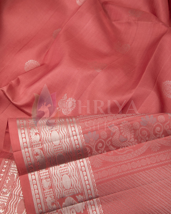 Close-up of rose pink silk fabric with detailed silver zari weaving