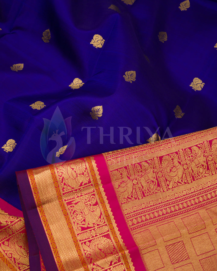 Close-up of soft royal blue Kanjivaram silk saree with golden buttas and rich zari pallu from Thriya Silks