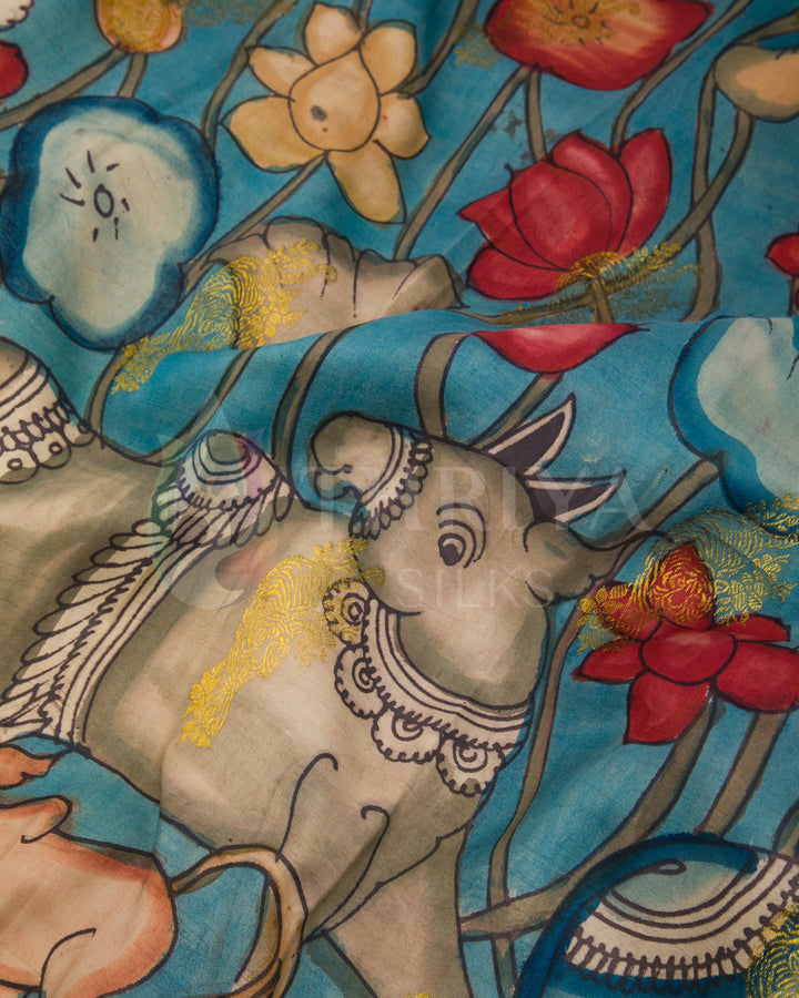 Detailed view of pallu featuring colorful hand-painted Kalamkari animal and floral motifs