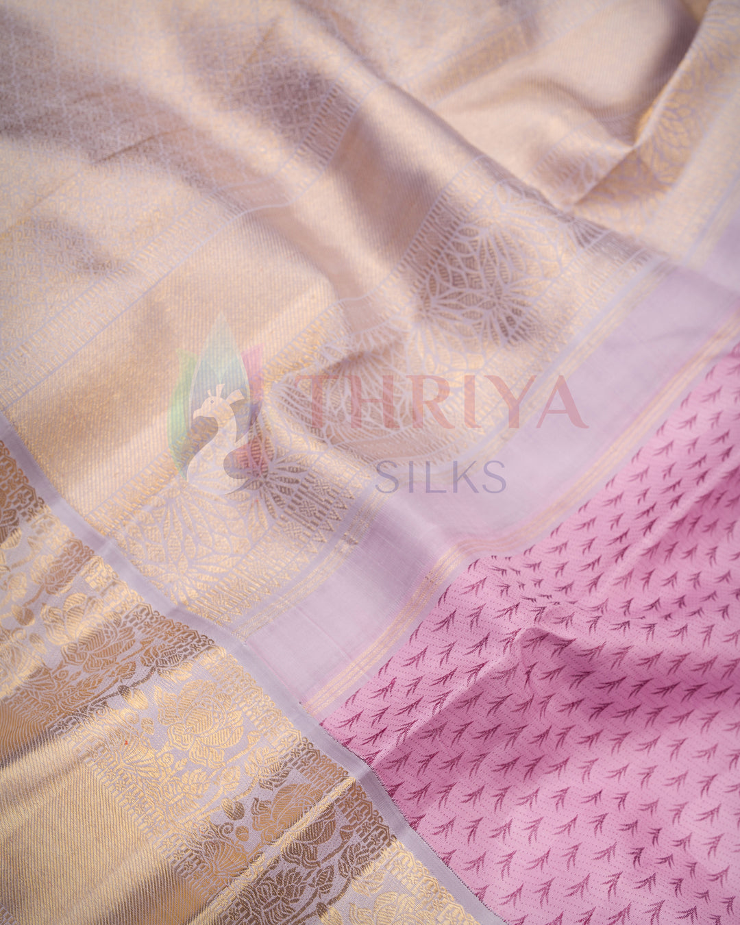 Close-up of soft pink and lavender Kanjivaram saree showcasing gold zari pallu and floral motifs