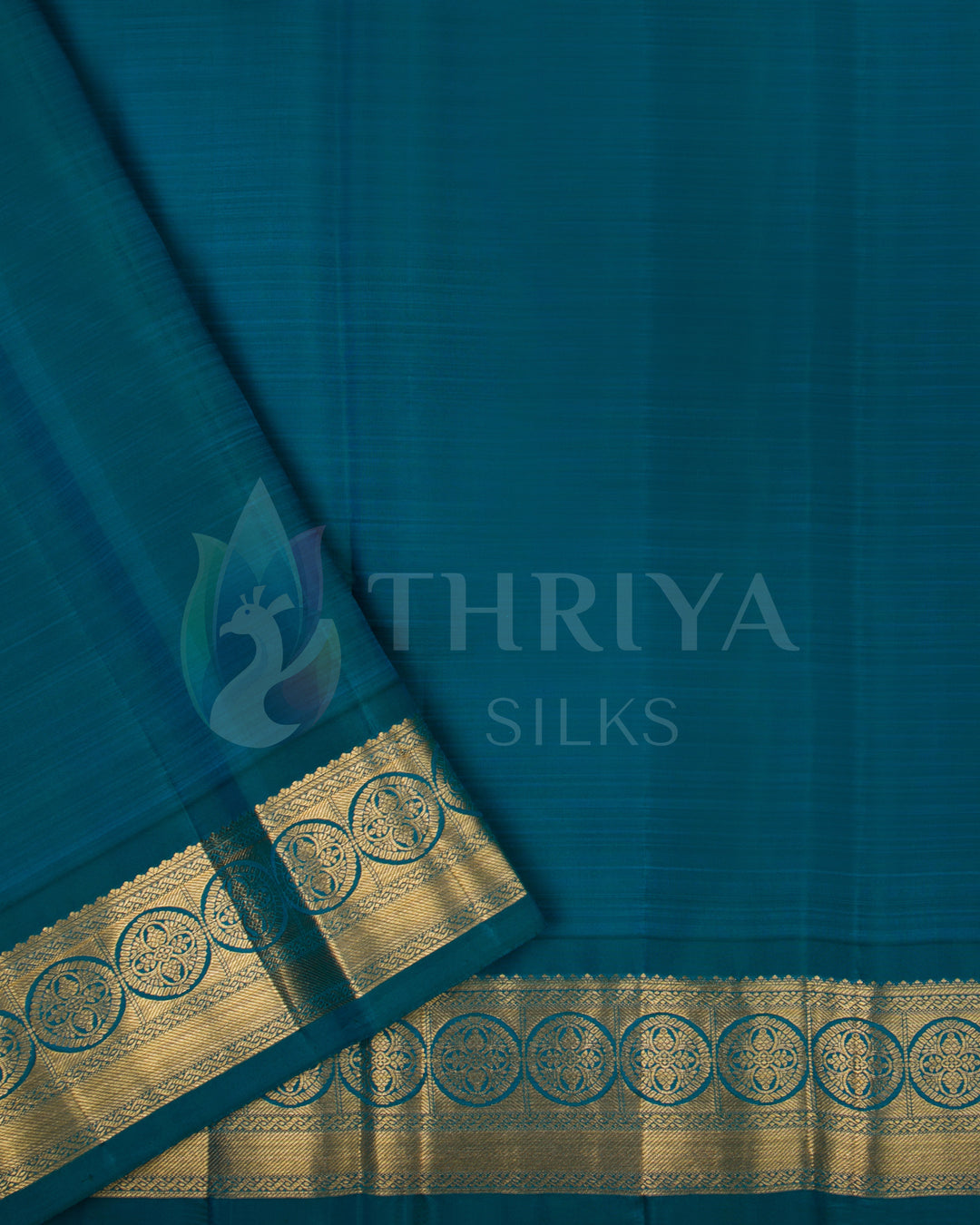 Plain deep teal blouse piece with broad gold zari border design