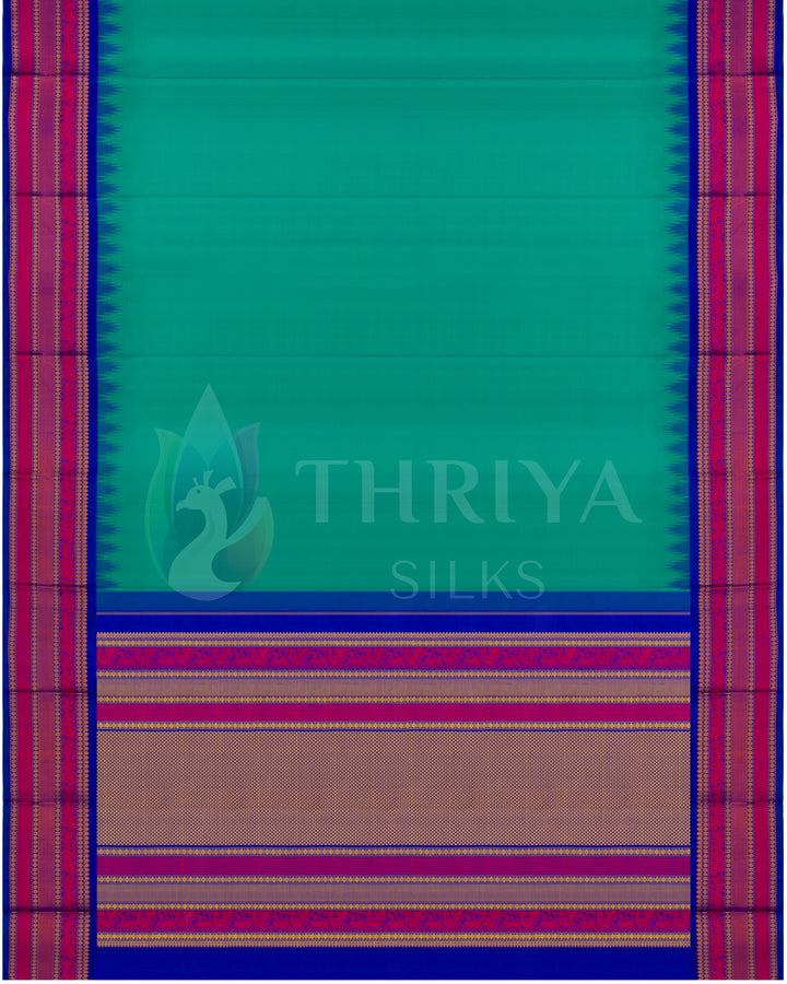 Full top view of teal green silk saree with contrast zari border and pallu – authentic design by Thriya Silks