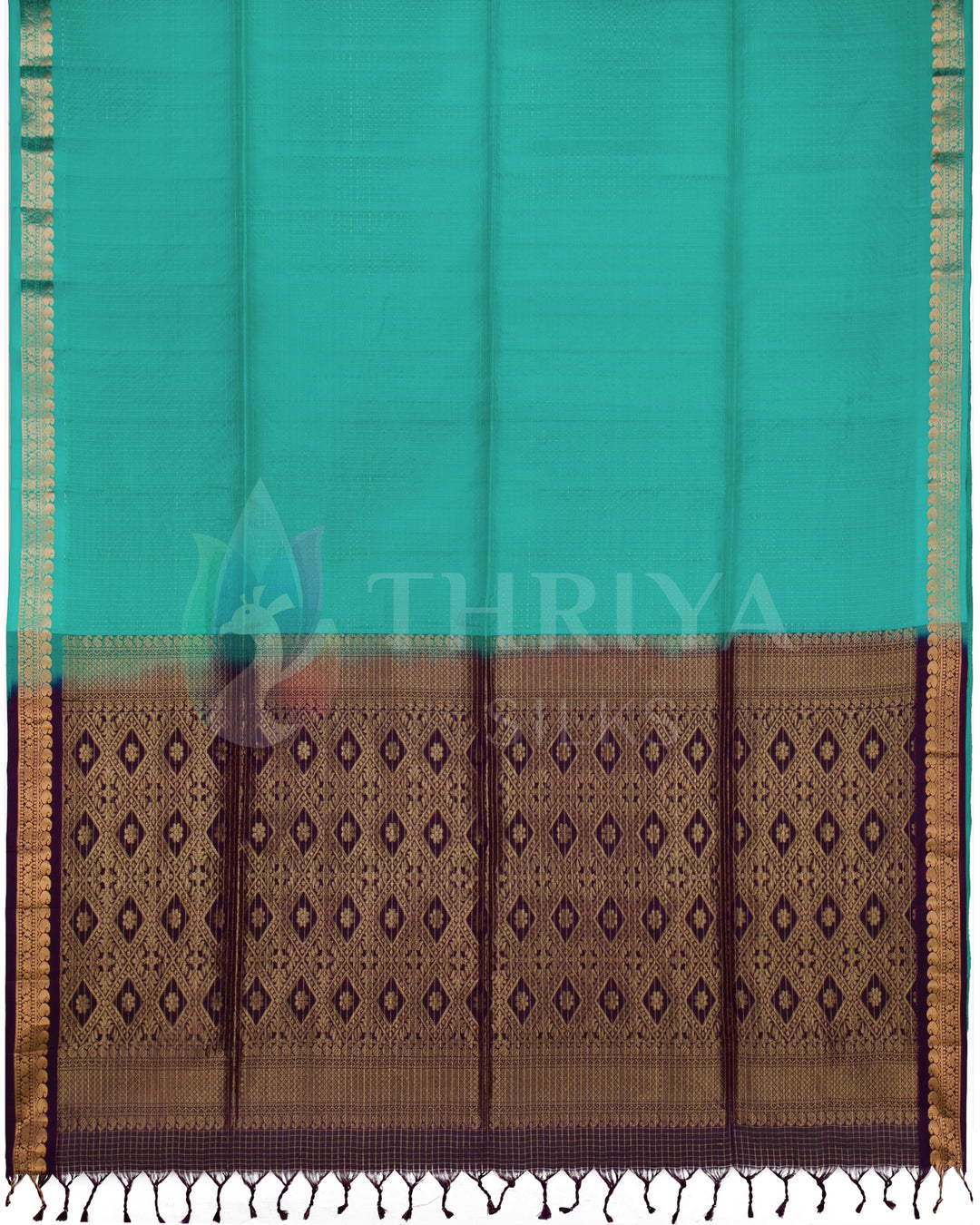 Full view of silk saree featuring teal green body and rich purple pallu with intricate gold motifs