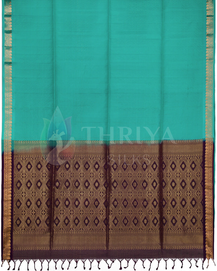 Full view of silk saree featuring teal green body and rich purple pallu with intricate gold motifs
