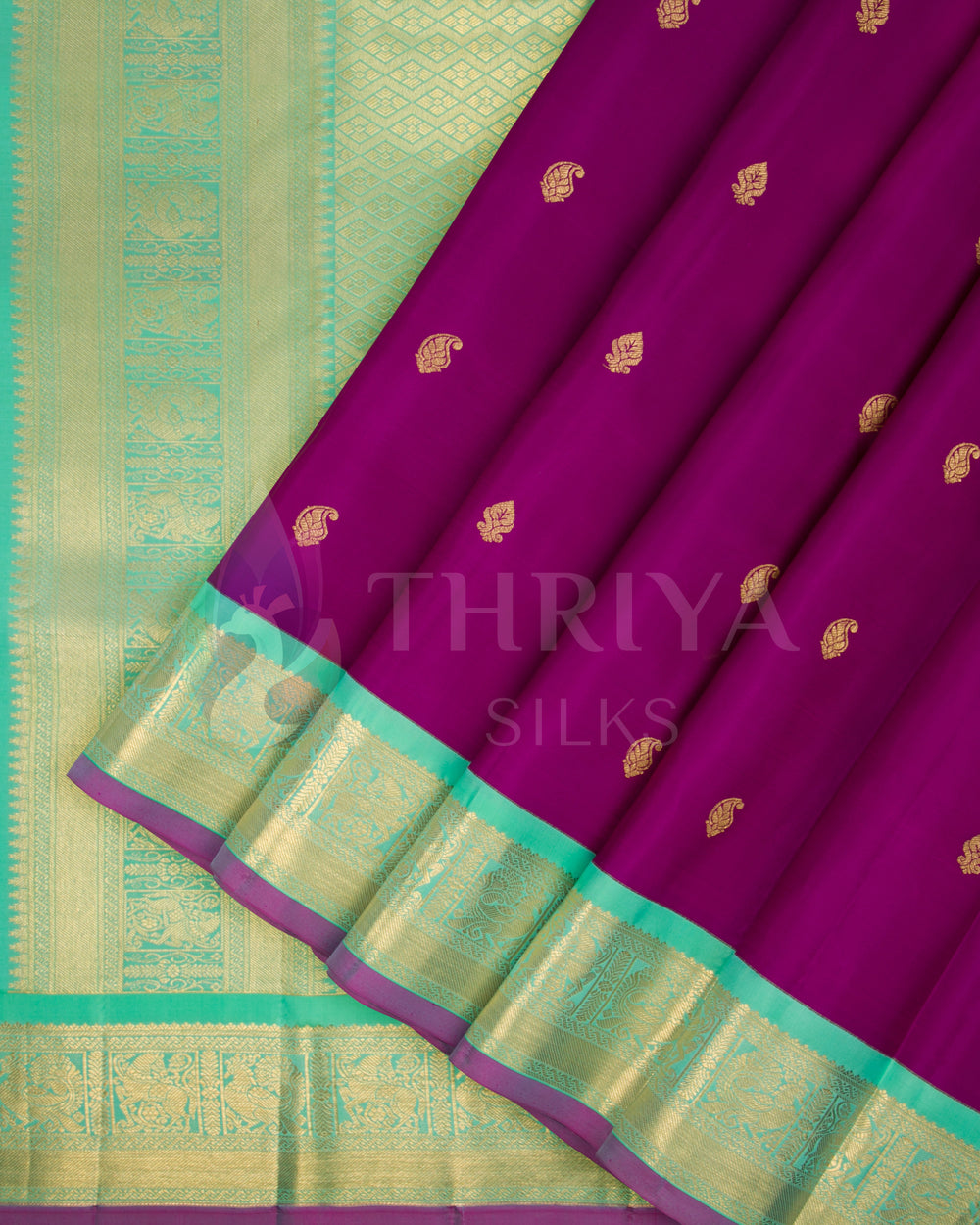 Close-up of Thriya Kanchipuram silk saree with purple body and shimmering green-gold zari border