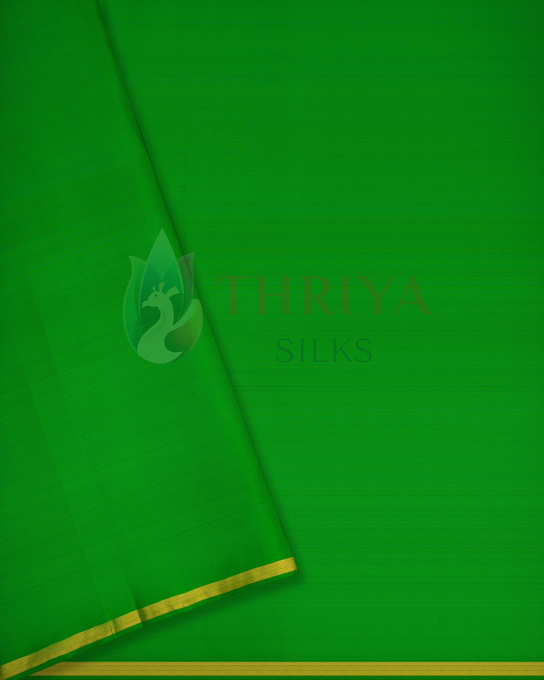 Green Kanchipuram silk saree with small gold buttas and rich pink zari pallu
