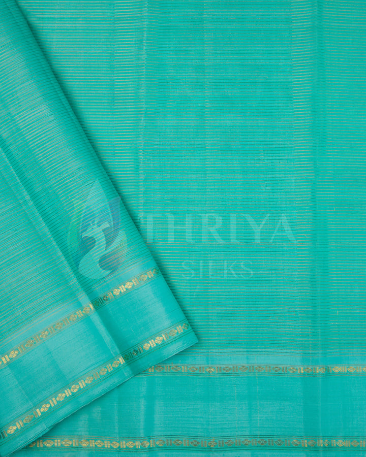Matching turquoise silk blouse piece with gold border included with Thriya black silk saree