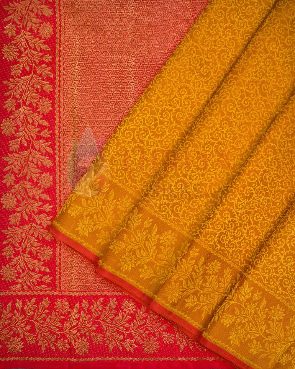 Yellow-orange Kanjivaram silk saree with intricate floral golden zari weave and contrasting red border
