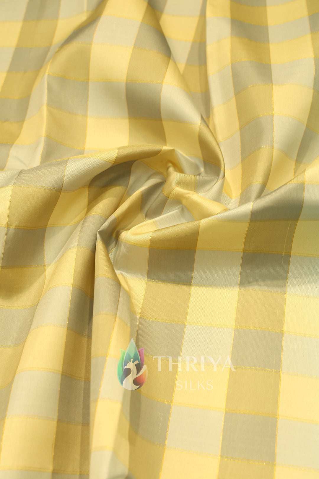 Silk saree body in light yellow with broad golden checks and smooth texture.