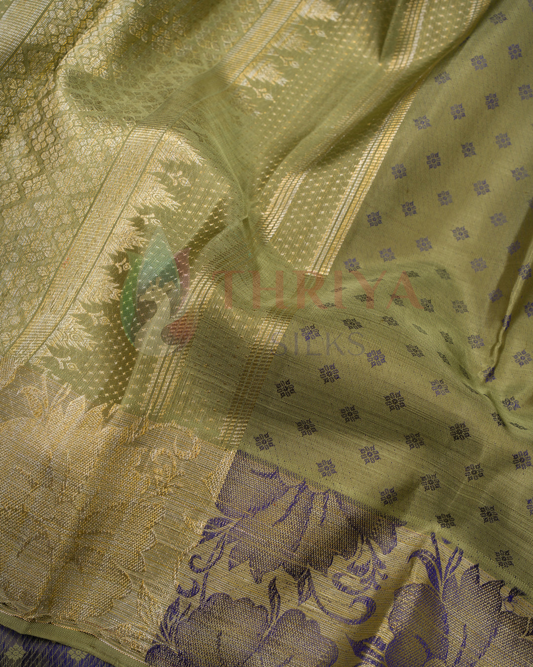 Zari weave detail on olive green Kanchipuram silk saree with violet motifs – trending 2025 design